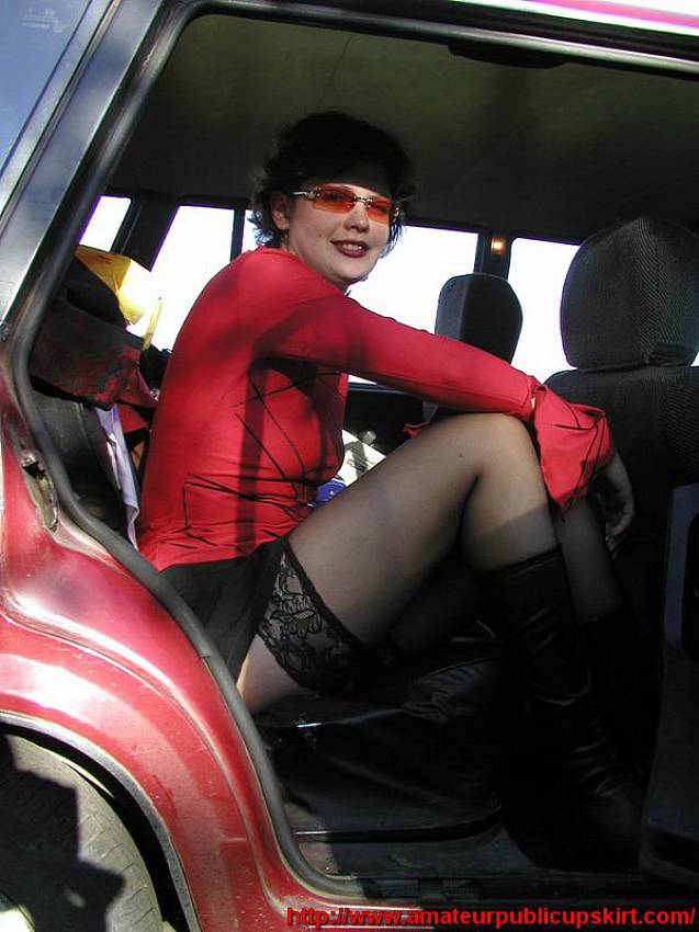 Stylish chick steps out of the car flashing her sexy black stockings..