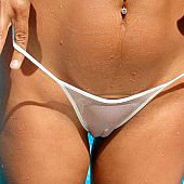 A bikini gal going topless on the Cap d'Agde.