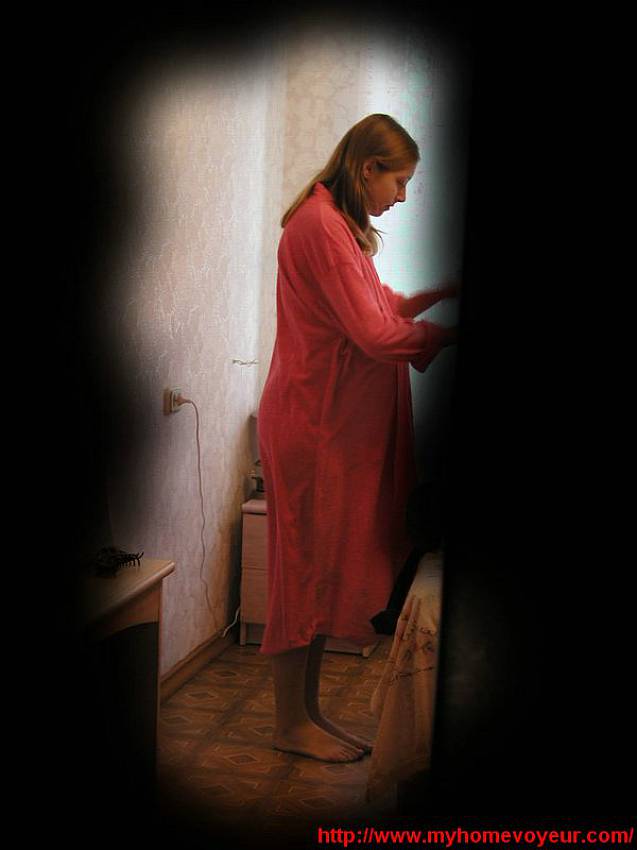 Lovely pregnant woman photographed through the keyhole in the moment..