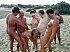 Nudist Beach - Bare gals sunbathes fully nude.