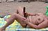 Nudist Beach - Exposed angels sunbathes nude.