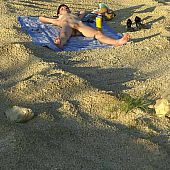 Slender angel lying naked on the beach.